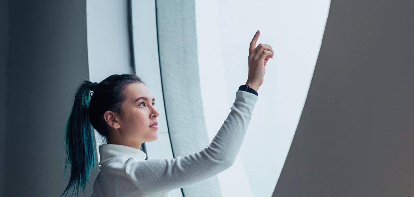 girl-using-touch-screen-modern-smart-home 2-min girl-using-touch-screen-modern-smart-home 2-min